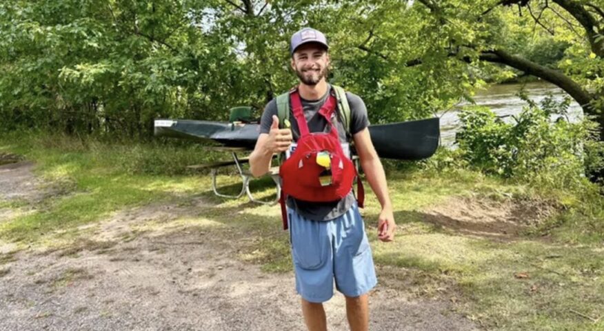 Kyle beside canoe